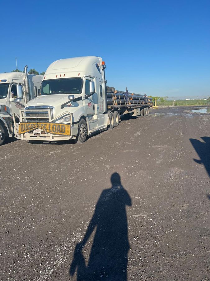 Two Right Path Trucking flatbed units staged together on a gravel lot