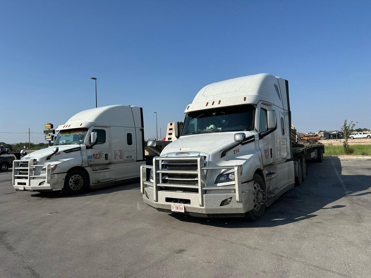 Two Right Path Trucking Freightliner Cascadia tractors parked side by side at the Edmonton yard